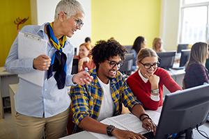 Teacher with students in a computer lab